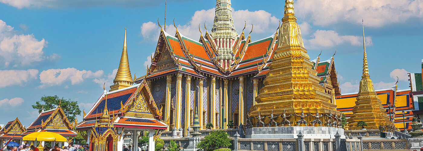 The Grand Palace, a landmark in Bangkok, with a blue sky in the background The Grand Palace, a landmark in Bangkok, with a blue sky in the background